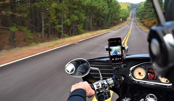 Motorcycle Trip Packing List: The Complete Guide Smartphone mounted on motorcycle handlebars for navigation