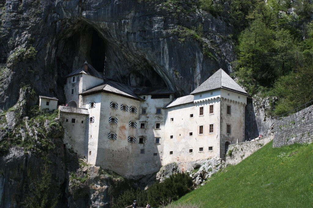 Slovenia Motorcycle Travel Guide Routes, Costs, and Tips Predjama Castle in Slowenia, approximately 11 kilometres from the town of Postojna and 9 kilometres from Postojna Cave