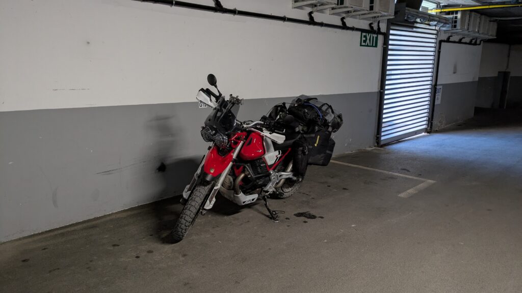 How to Find Cheap Accommodation for Motorcycle Touring Motorcycle parked in a locked garage — secure overnight parking for motorcycle touring