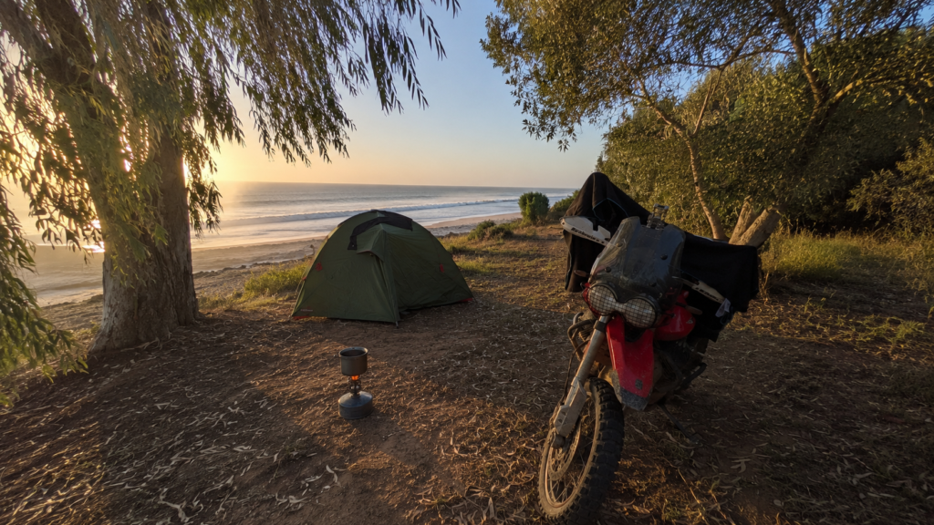 Motorcycle parked outside cheap accommodation on a European touring trip
