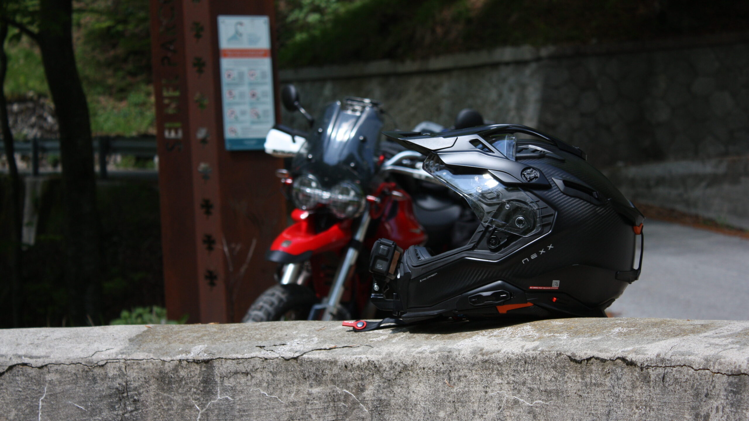 Essential Camera Gear for Motorcycle Travel Photography Action camera mounted on helmet for POV riding footage and video content during touring