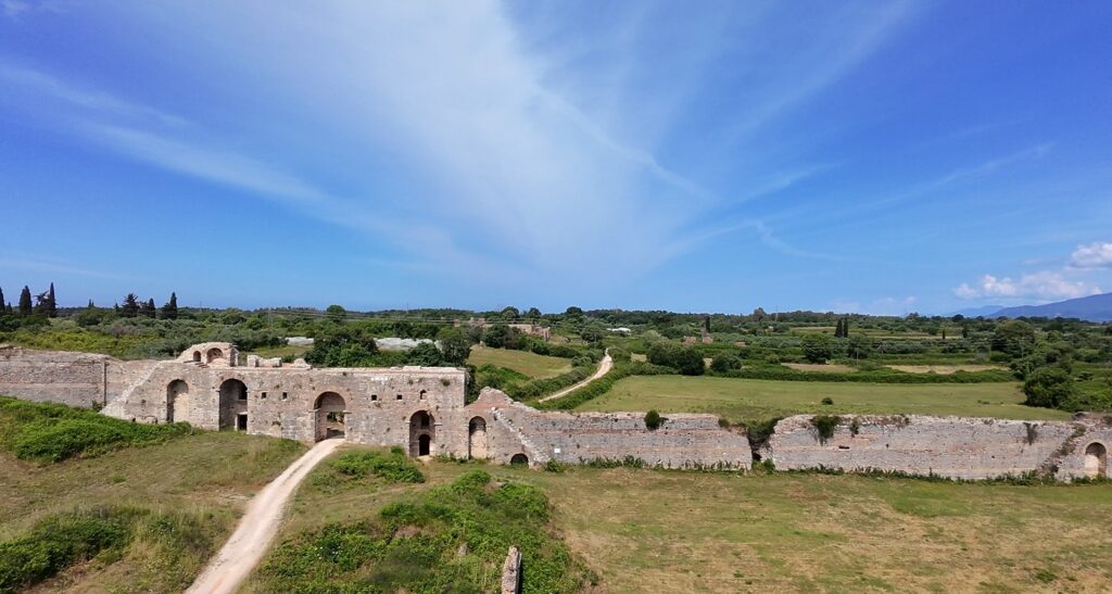 Essential Camera Gear for Motorcycle Travel Photography Aerial drone shot of ancient ruins in Greece — DJI Neo motorcycle travel photography perspective