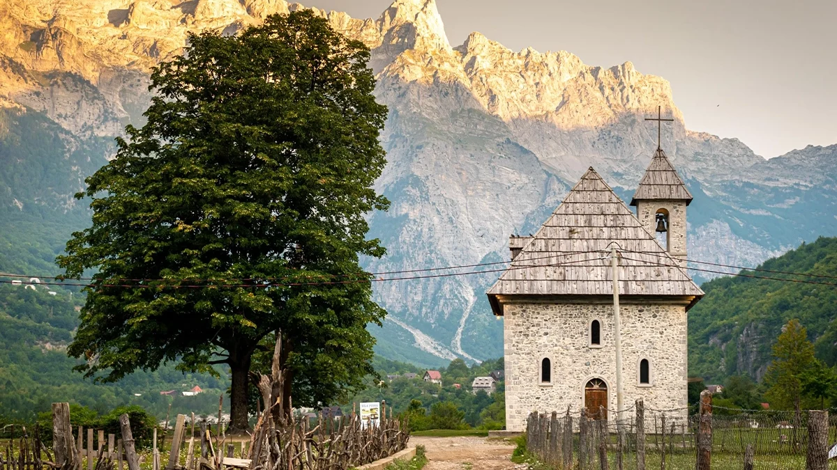 Albania Motorcycle Travel Guide: The Balkans' Hidden Gem Dramatic Albanian Alps scenery in Theth or Valbona Valley showing mountain peaks and valley road for albania motorcycle travel