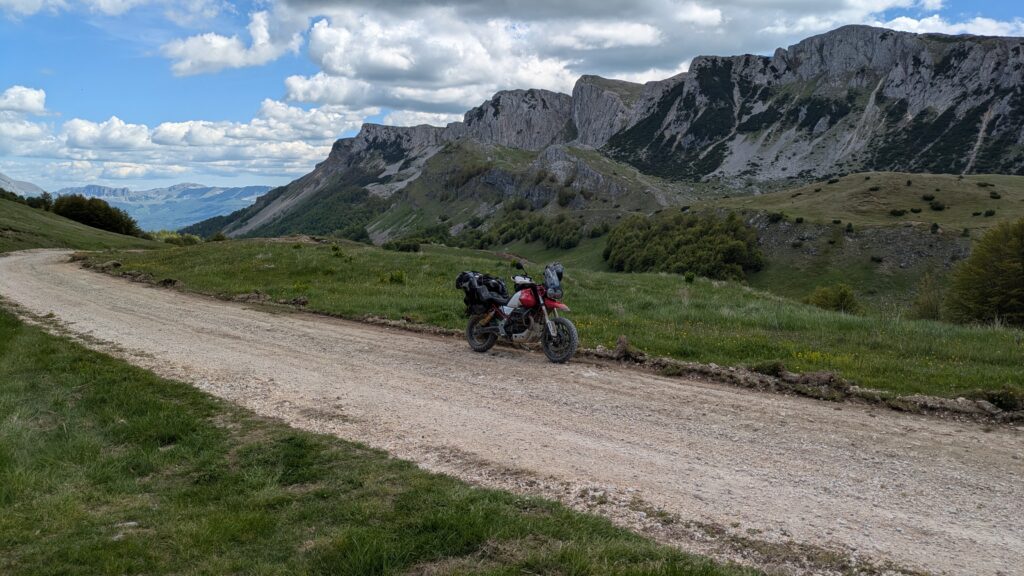 Balkan Motorcycle Route: Plan Your Best 2-Week Trip Motorcycle on empty scenic Balkan road at golden hour showing the adventure riding available on the 2-week Balkan motorcycle route