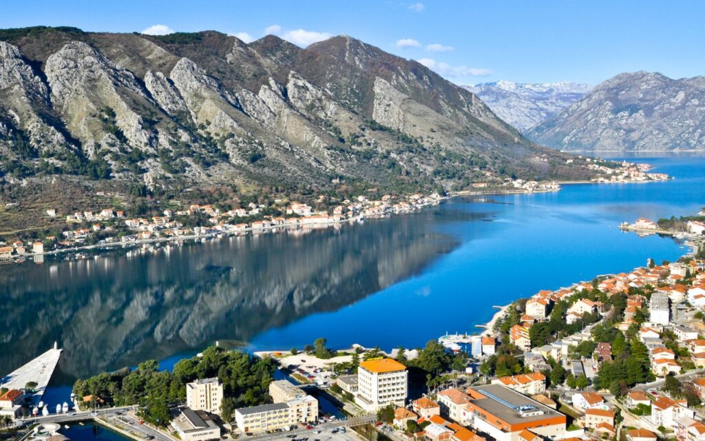 Balkan Motorcycle Route: Plan Your Best 2-Week Trip Bay of Kotor in Montenegro with serpentine road climbing above the bay on the Balkan motorcycle route