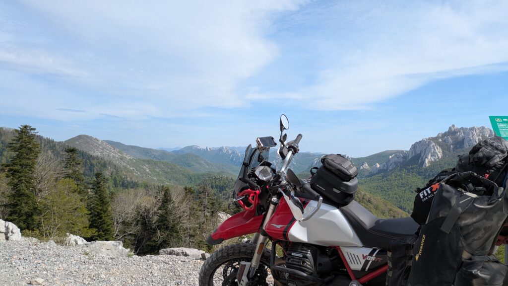 Budget Motorcycle Travel Europe: The Complete Guide Motorcycle on empty scenic road in Eastern Europe at golden hour showing the freedom and value of budget motorcycle travel europe