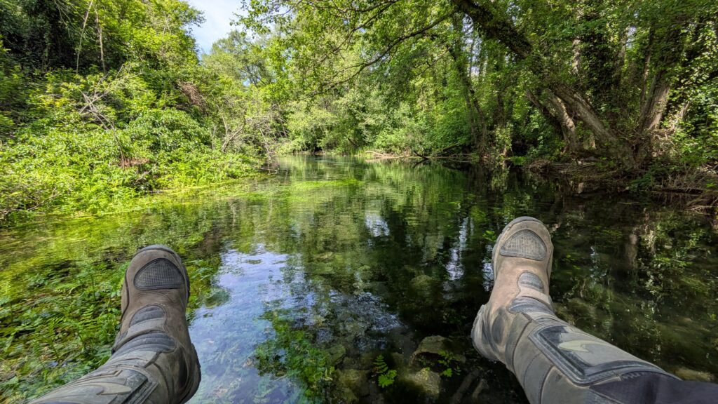 Budget Motorcycle Travel Europe: The Complete Guide Wild swimming in river showing free activities available on budget motorcycle travel europe