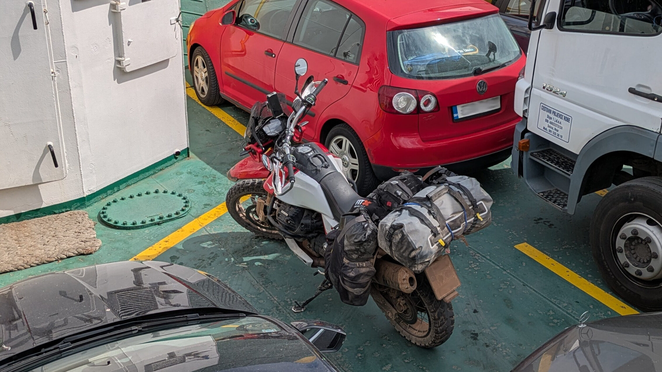 Motorcycle loaded on Jadrolinija ferry crossing to Croatian island with Adriatic Sea