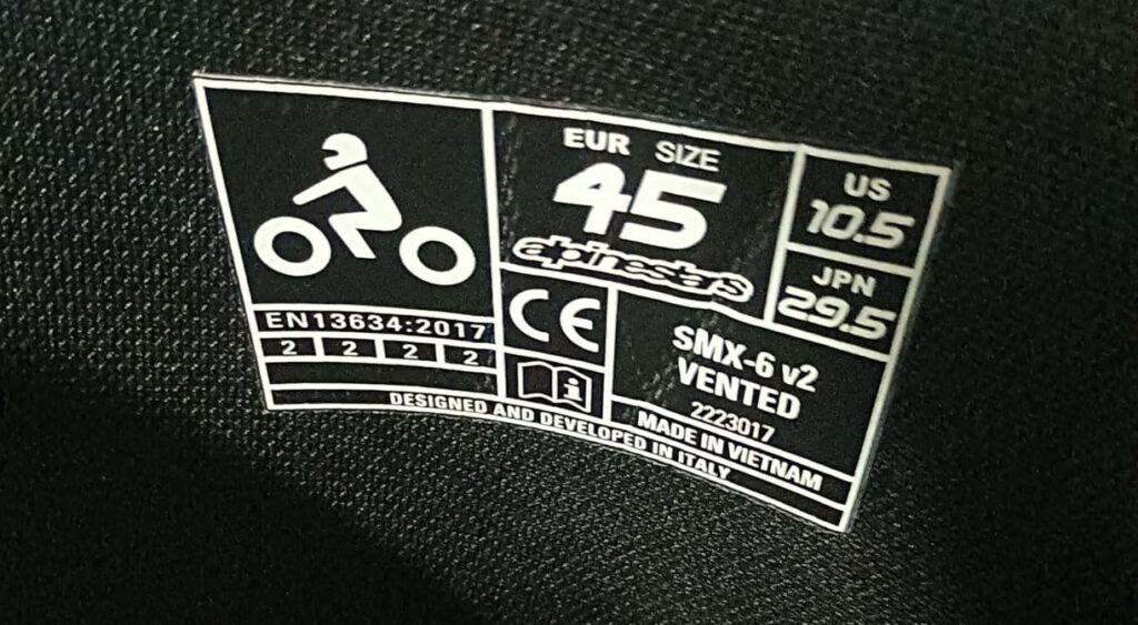 CE certification label inside motorcycle touring boot showing EN 13634 protection standard