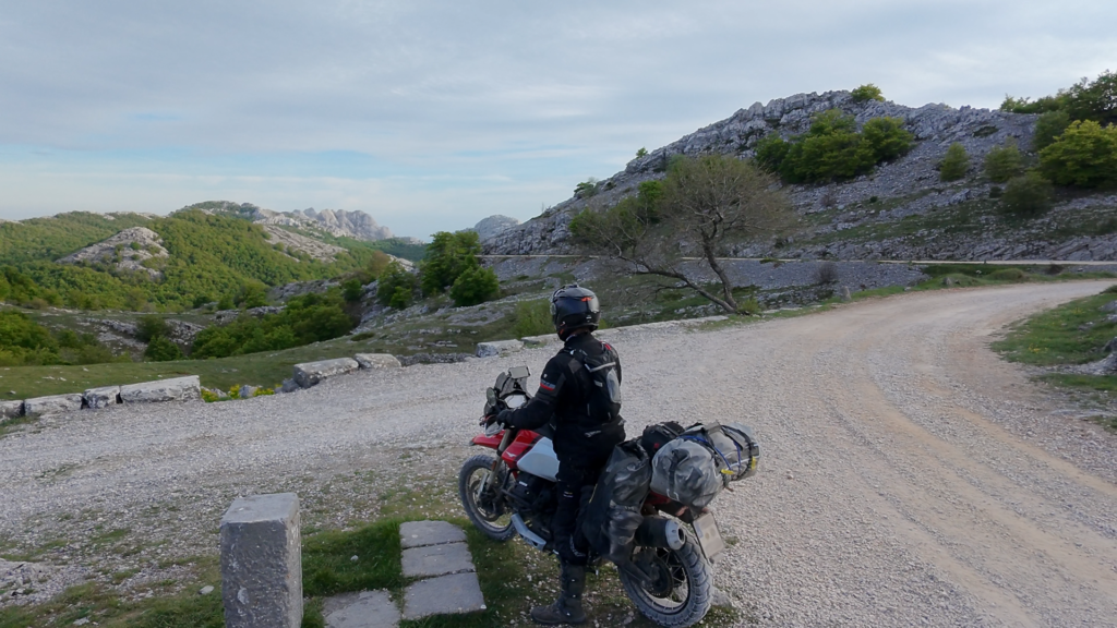 Well composed motorcycle self portrait with rider and bike in dramatic landscape showing result of solo motorcycle self portrait photography techniques