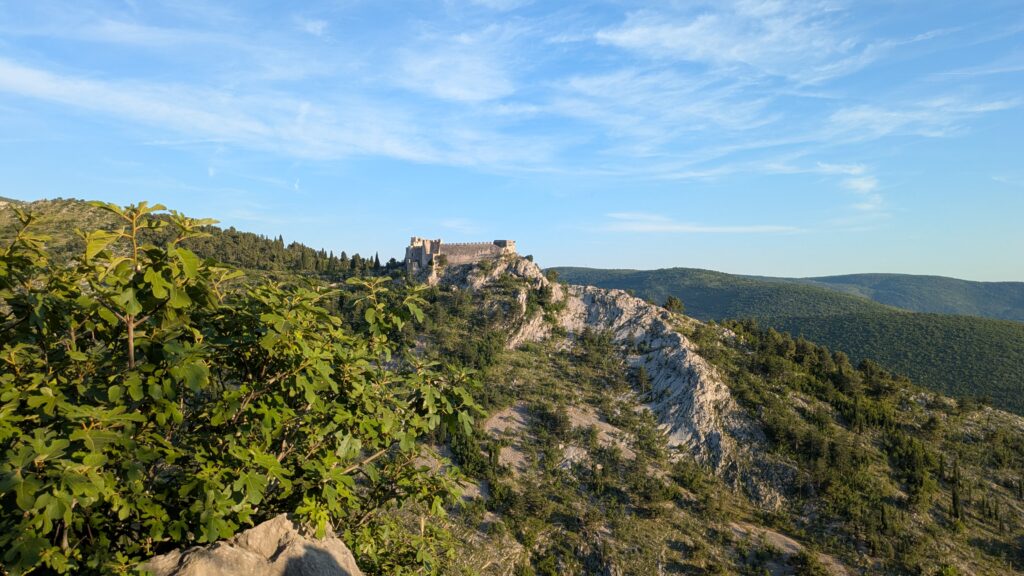 Bosnia and Montenegro Motorcycle Travel Guide Motorcycle on scenic mountain road in Bosnia or Montenegro at golden hour showing variety and drama of the montenegro bosnia motorcycle experience