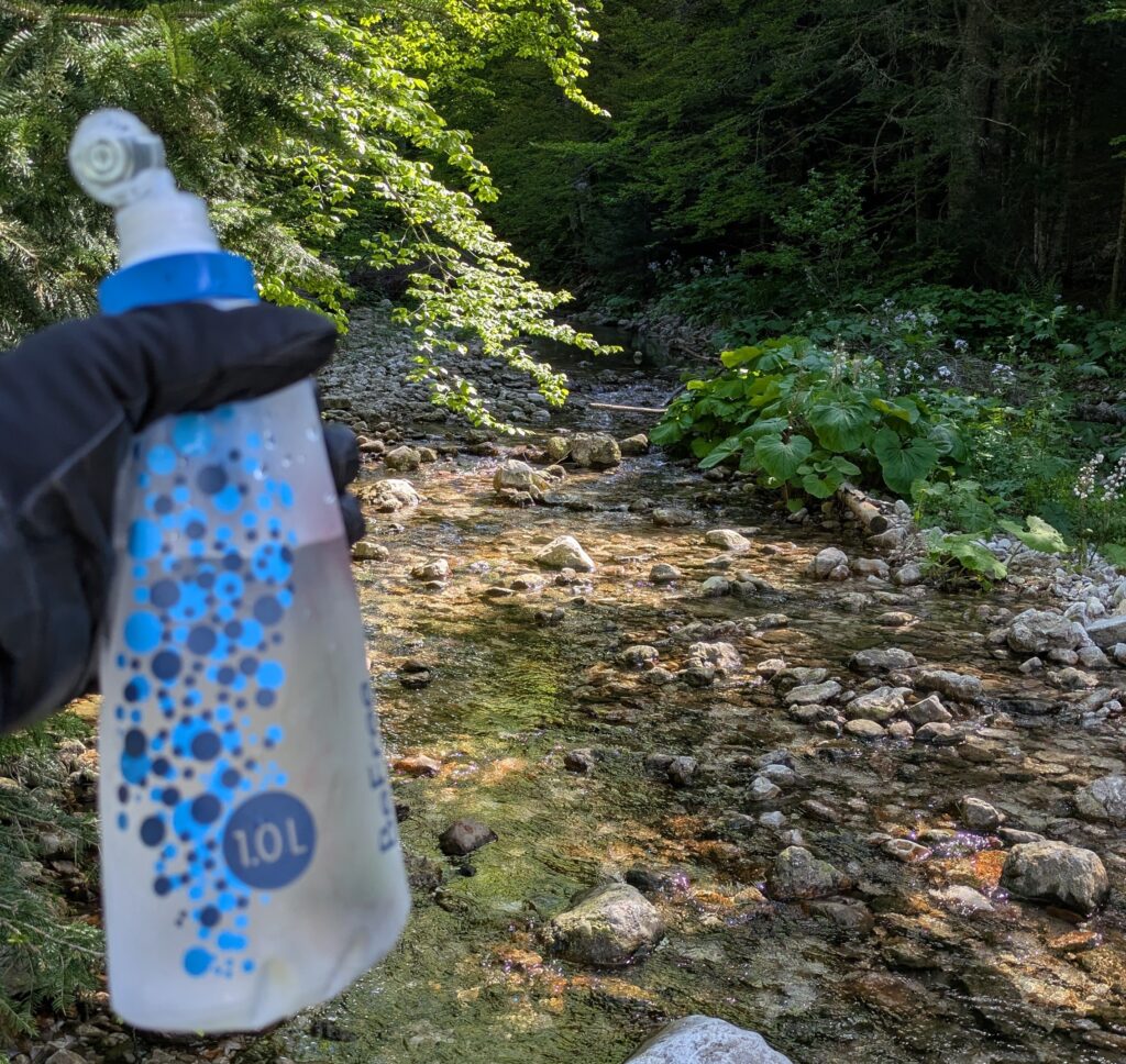 Public drinking fountain in European town square showing free water refill option for motorcycle touring hydration