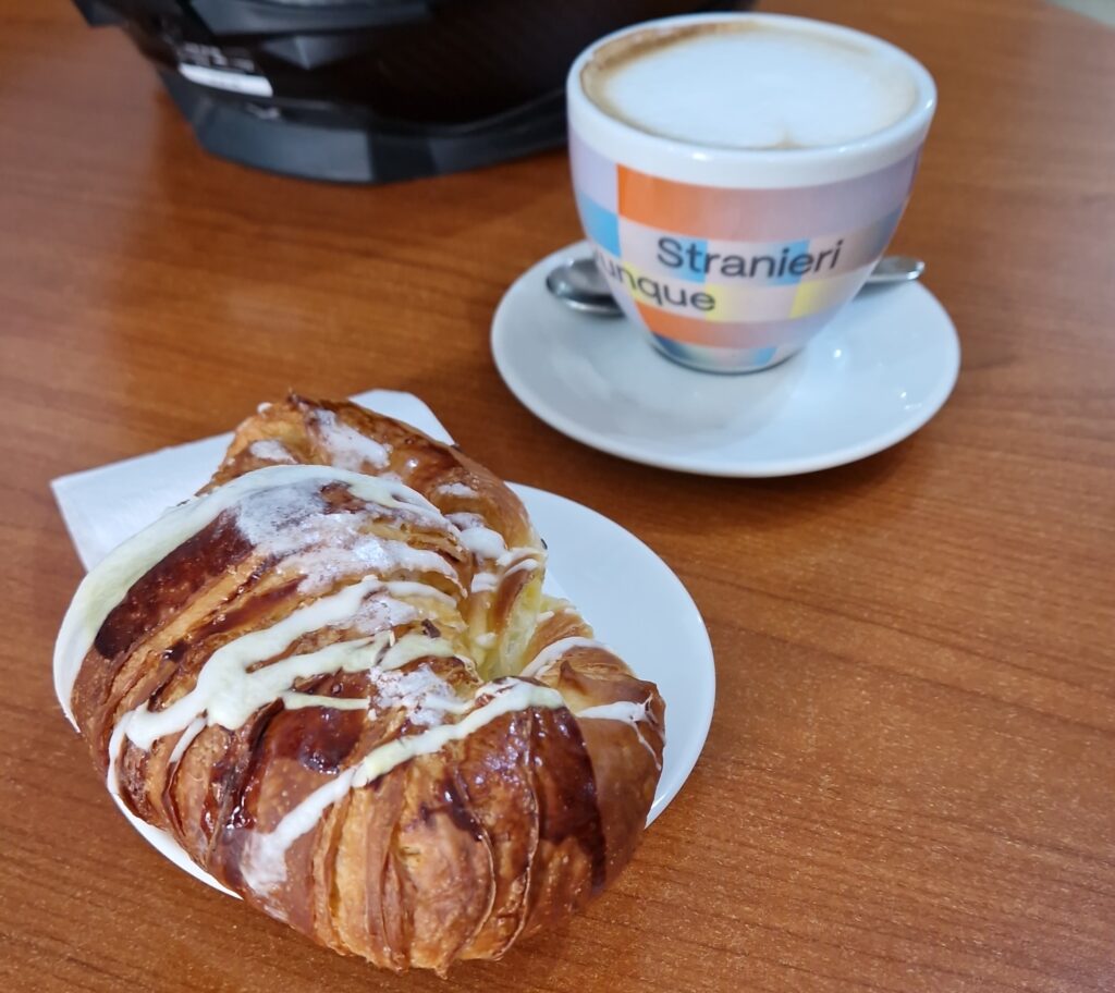 italian breakfast coffee and a cornetto as example for cheap food