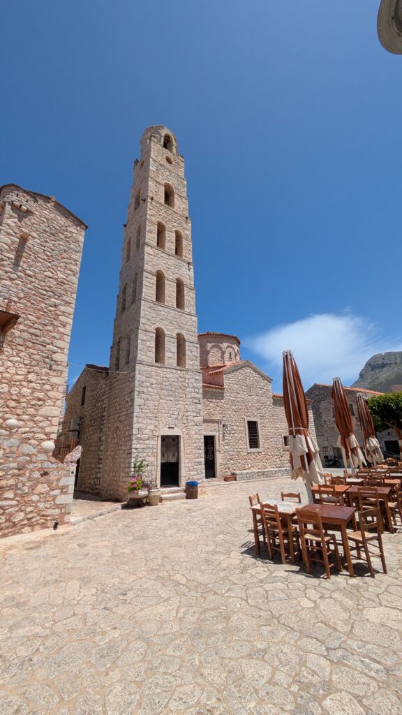 Greece Motorcycle Travel Guide: Routes and Tips Mani Peninsula in the Peloponnese showing traditional tower houses against rocky landscape on greece motorcycle travel route