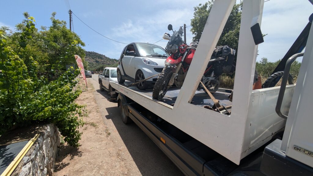 Motorcycle Travel Insurance Europe: What You Need Motorcycle being loaded onto recovery truck showing why comprehensive breakdown cover including repatriation is essential for european motorcycle travel