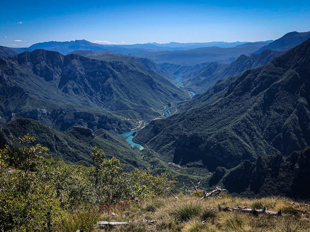 Bosnia and Montenegro Motorcycle Travel Guide Neretva canyon road in Bosnia with dramatic canyon walls and green river below showing one of Europe