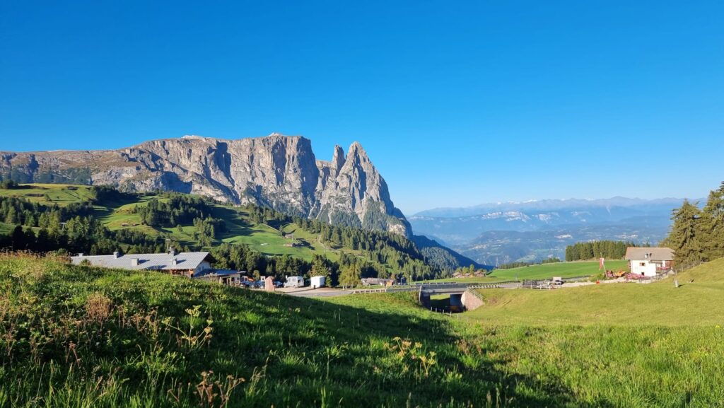 Northern Italy Motorcycle Routes: Dolomites and Alps Motorcycle on Dolomites pass road with dramatic pale limestone rock formations rising vertically showing northern italy motorcycle routes at their finest