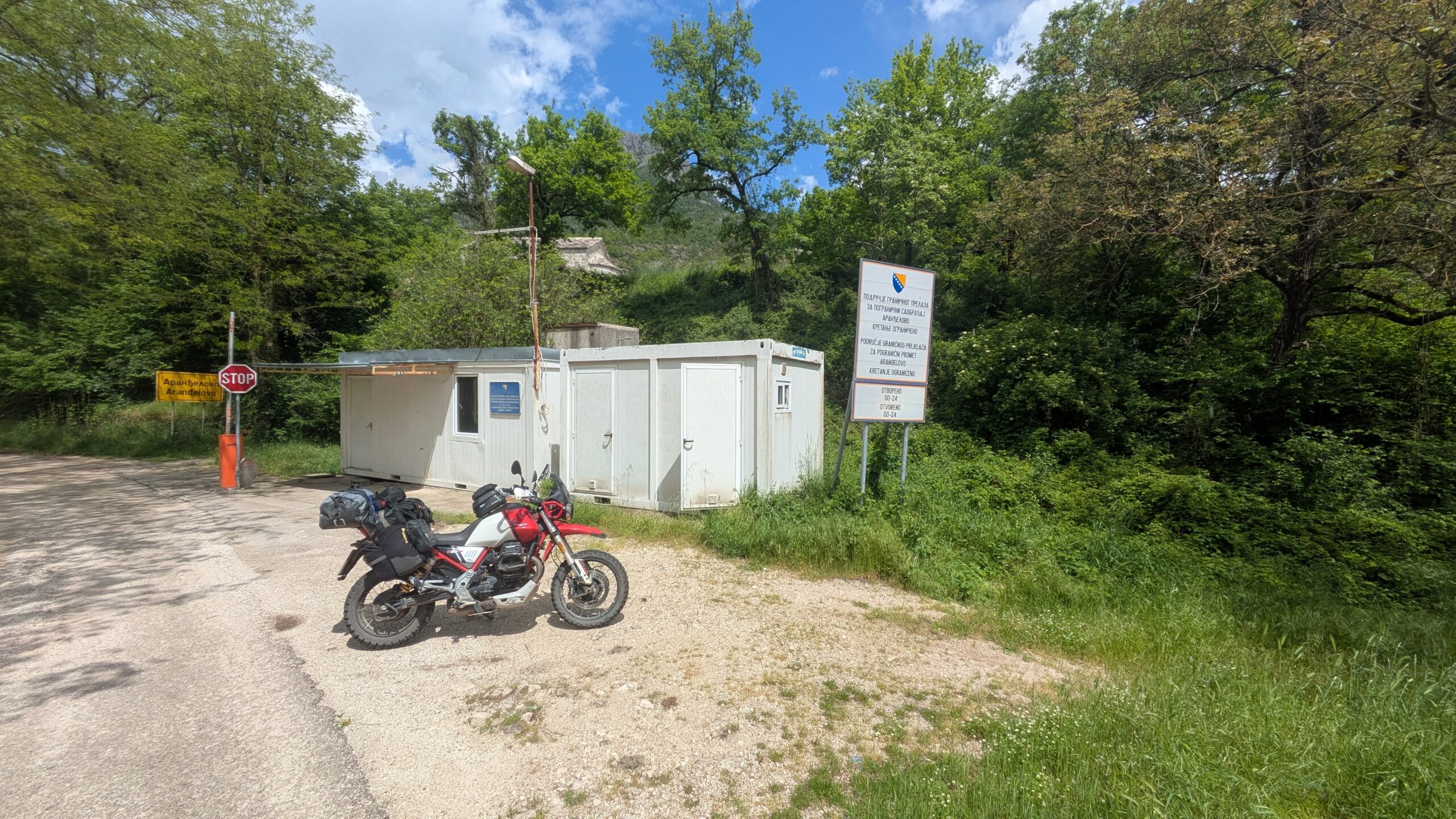 Travelling Europe Motorcycle at a European country border sign — travelling Europe by motorcycle