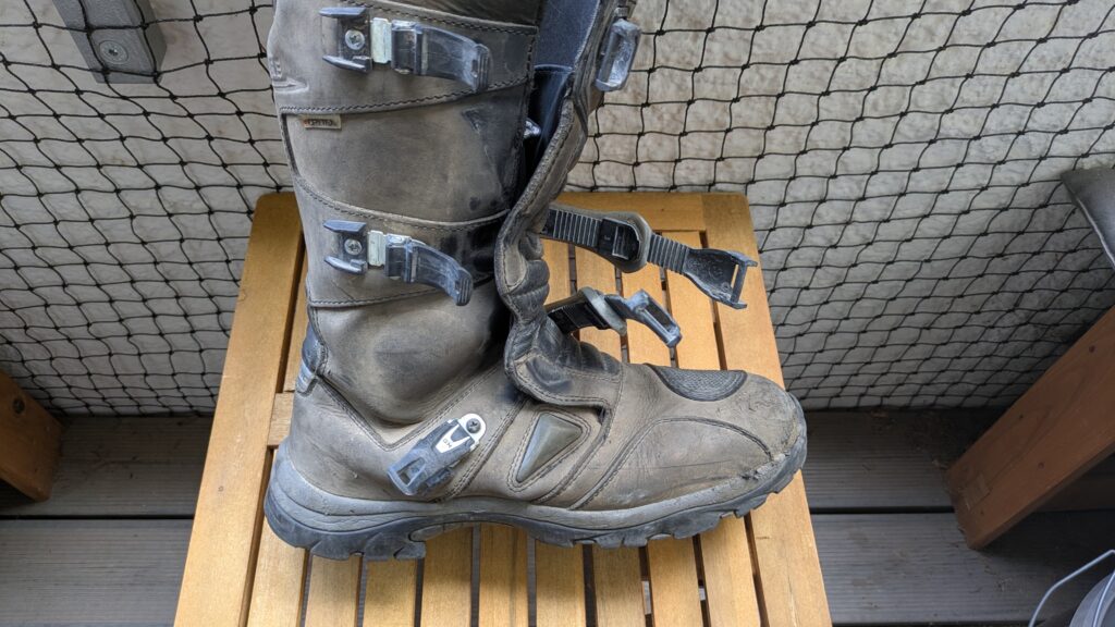 Motorcycle Riding Gear: The Complete Guide Motorcycle boot showing impact wear after Albania's ACT/TET route