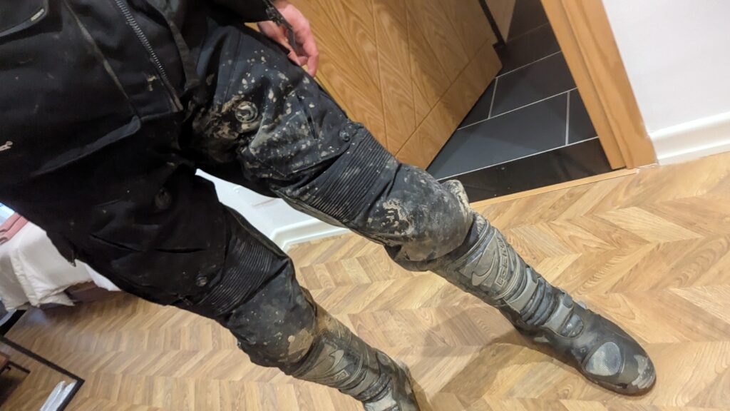 Motorcycle Riding Gear: The Complete Guide Motorcycle trouser leg overlapping the top of a touring boot
