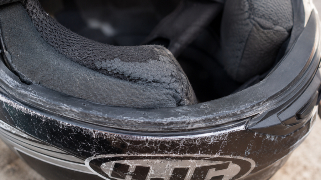 How to Choose the Right Motorcycle Helmet for Touring Worn motorcycle helmet interior showing signs of age-related degradation