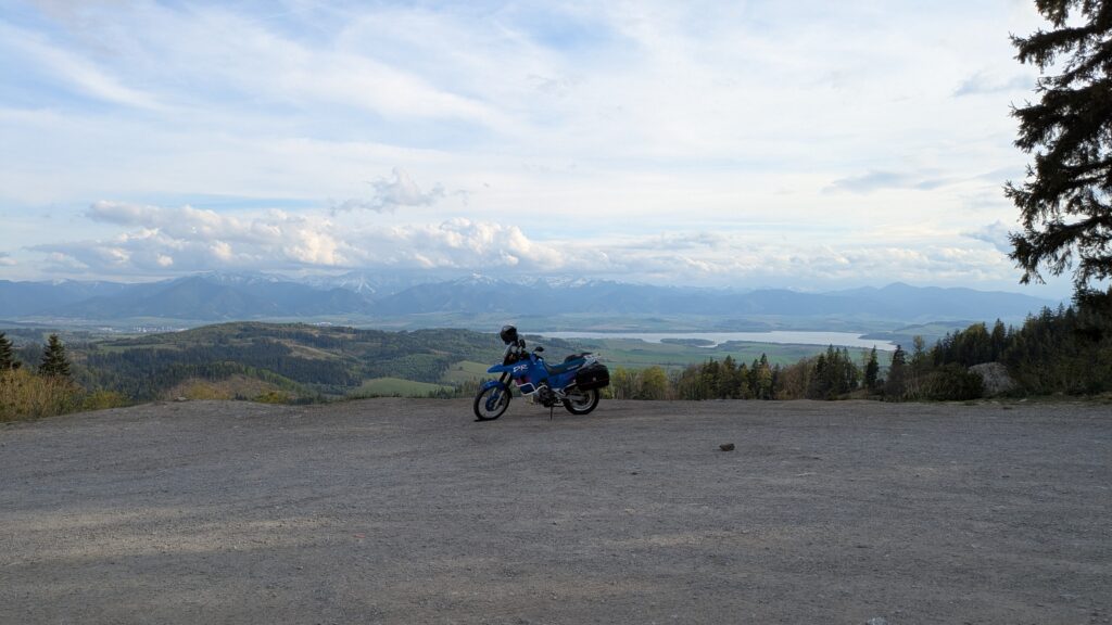 Slovakia Motorcycle Travel Guide: Routes and Top Tips Motorcycle on road 584 overlooking Liptovská Mara lake and the High Tatras